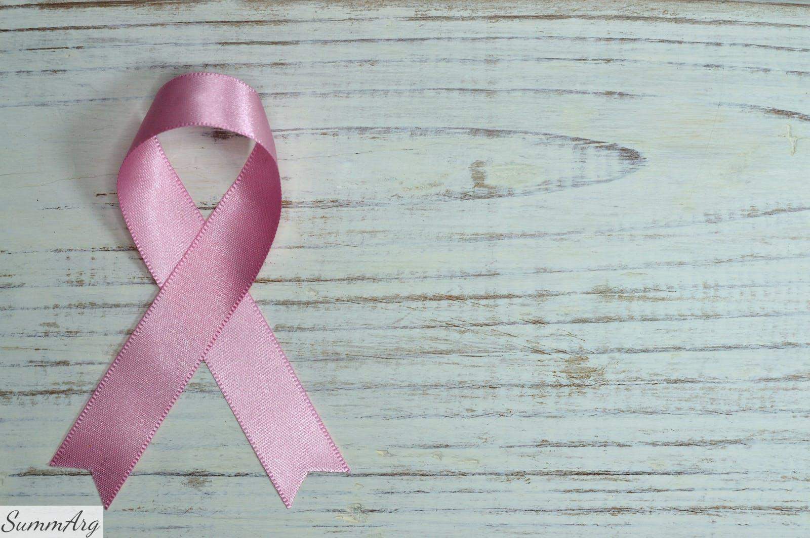 Breast Cancer Awareness on Teal Wooden Surface