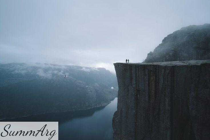 Two People On Mountain Cliff