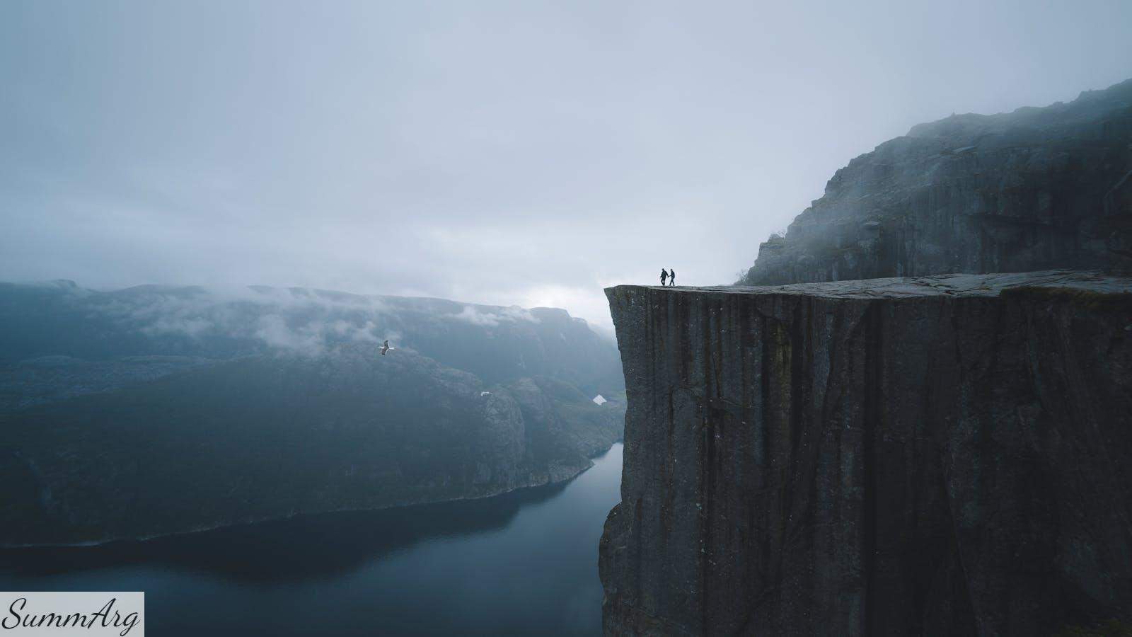Two People On Mountain Cliff