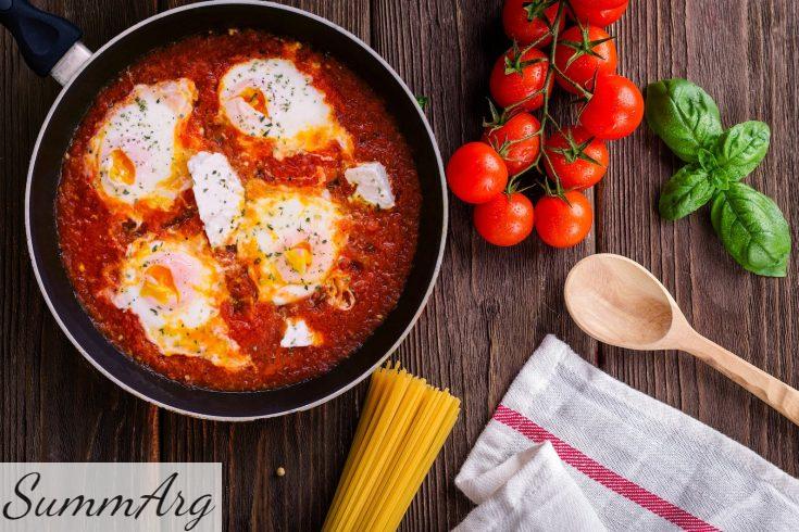Black Frying Pan With Spaghetti Sauce Near Brown Wooden Ladle and Ripe Tomatoes